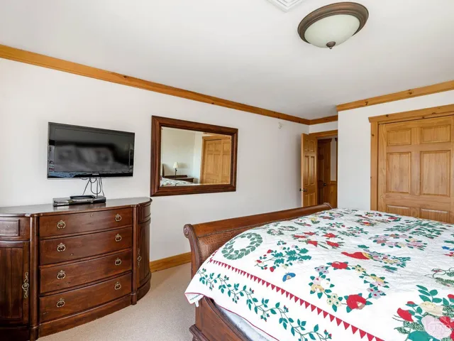 a view of a brick house with a yard table and chairs