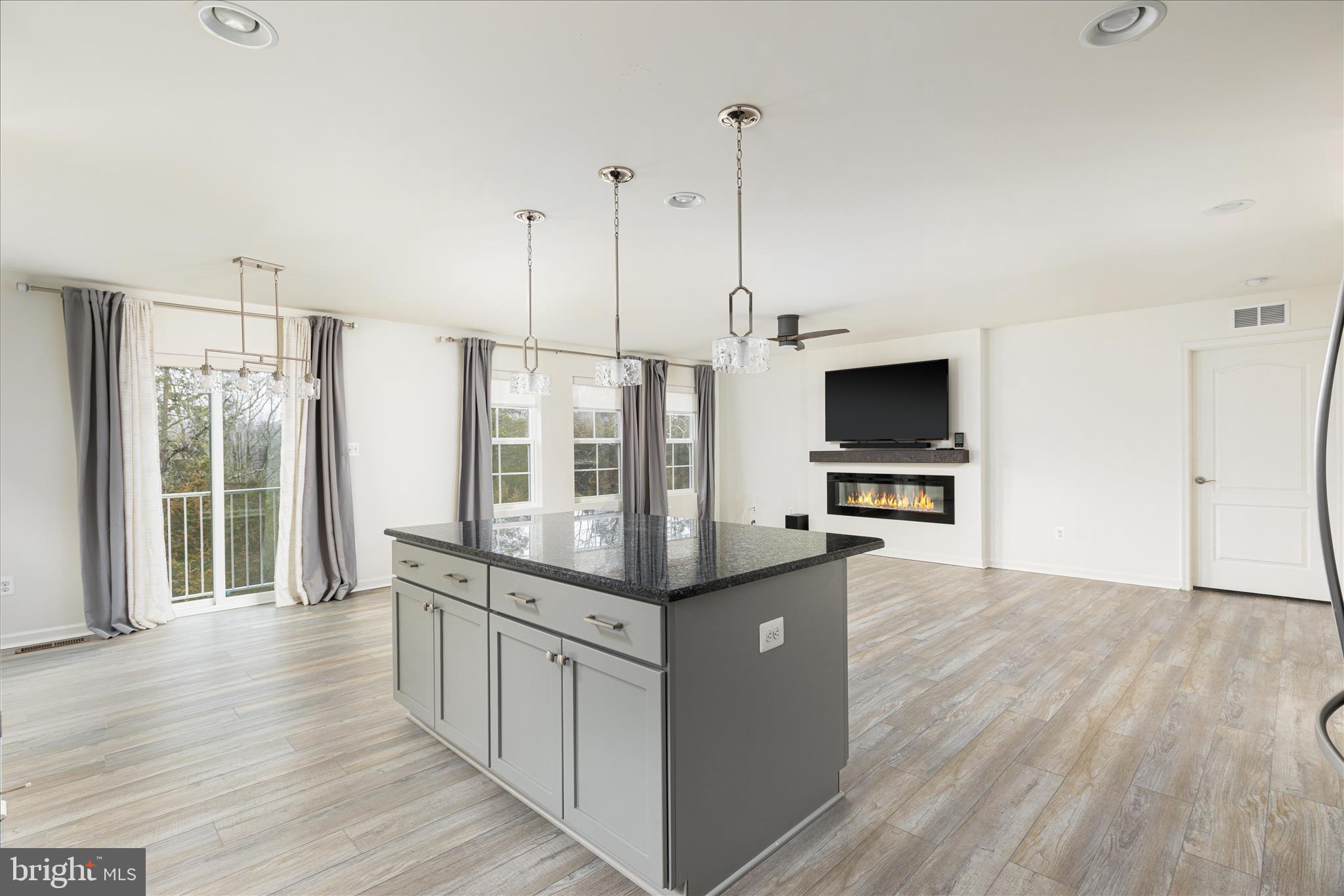 250 Stager Avenue Falling Waters, WV 25419 - Photo 13 of 31 a kitchen with stainless steel appliances kitchen island granite countertop a stove a sink and a wooden floors