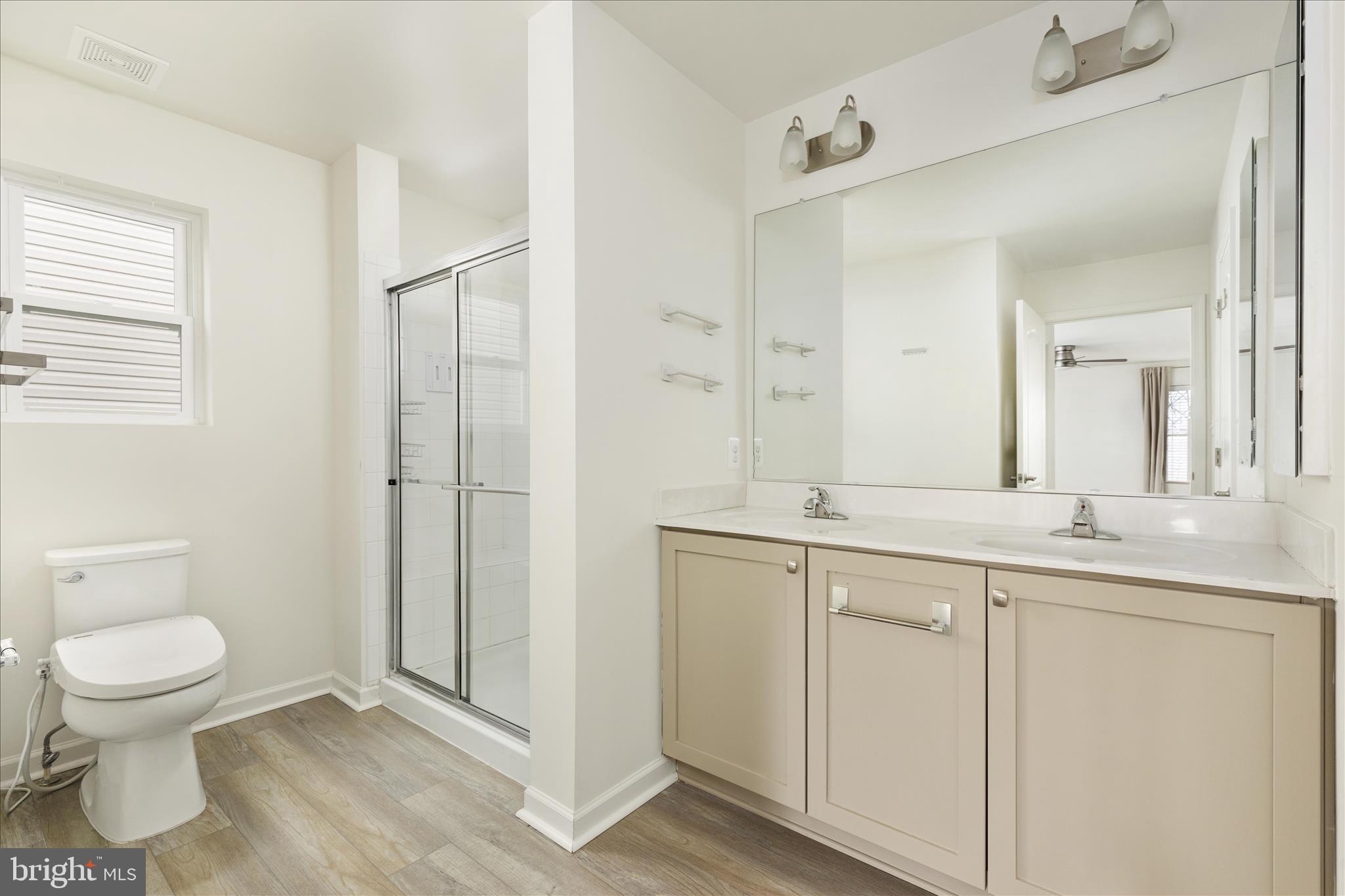 250 Stager Avenue Falling Waters, WV 25419 - Photo 22 of 31 a spacious bathroom with a granite countertop sink a toilet and a mirror