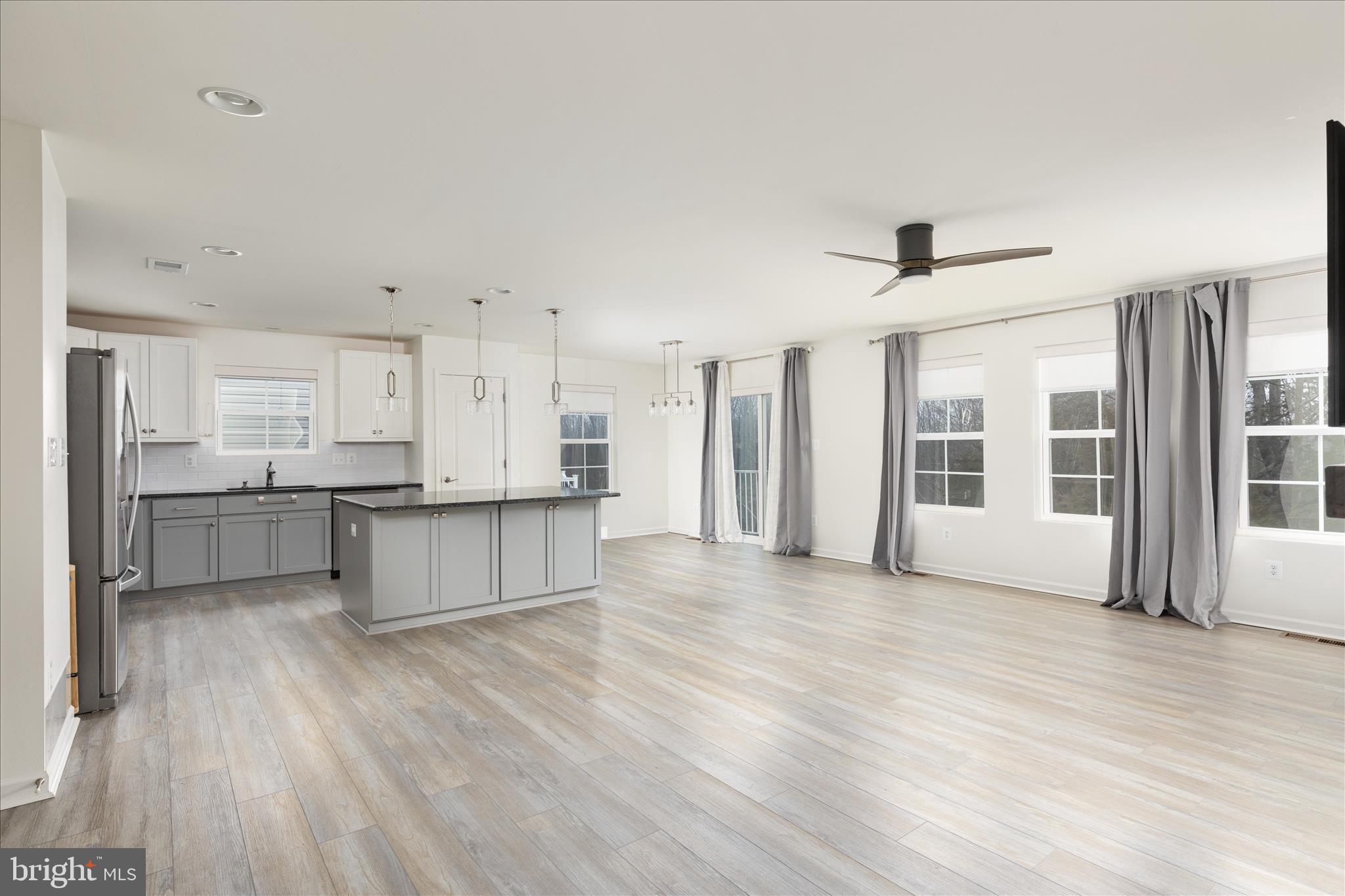 250 Stager Avenue Falling Waters, WV 25419 - Photo 6 of 31 a large white kitchen with wooden floors and white walls