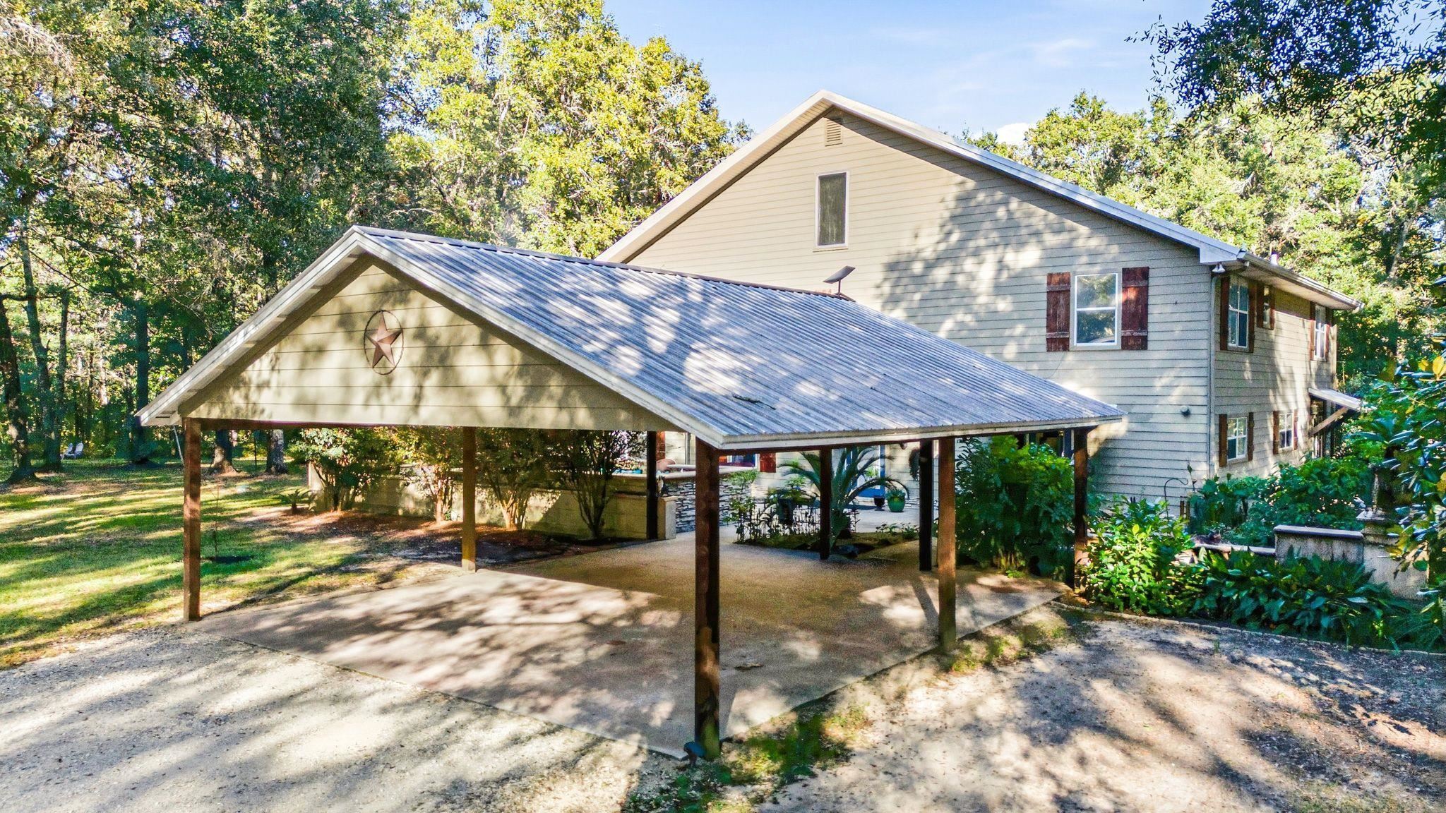 24250 River Road North Daphne, AL 36526 - Photo 6 of 80 View of patio / terrace featuring a hot tub, an outdoor stone fireplace, and view of scattered trees