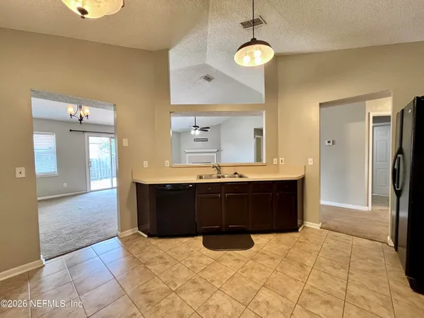 a room with a bed and a double vanity sink
