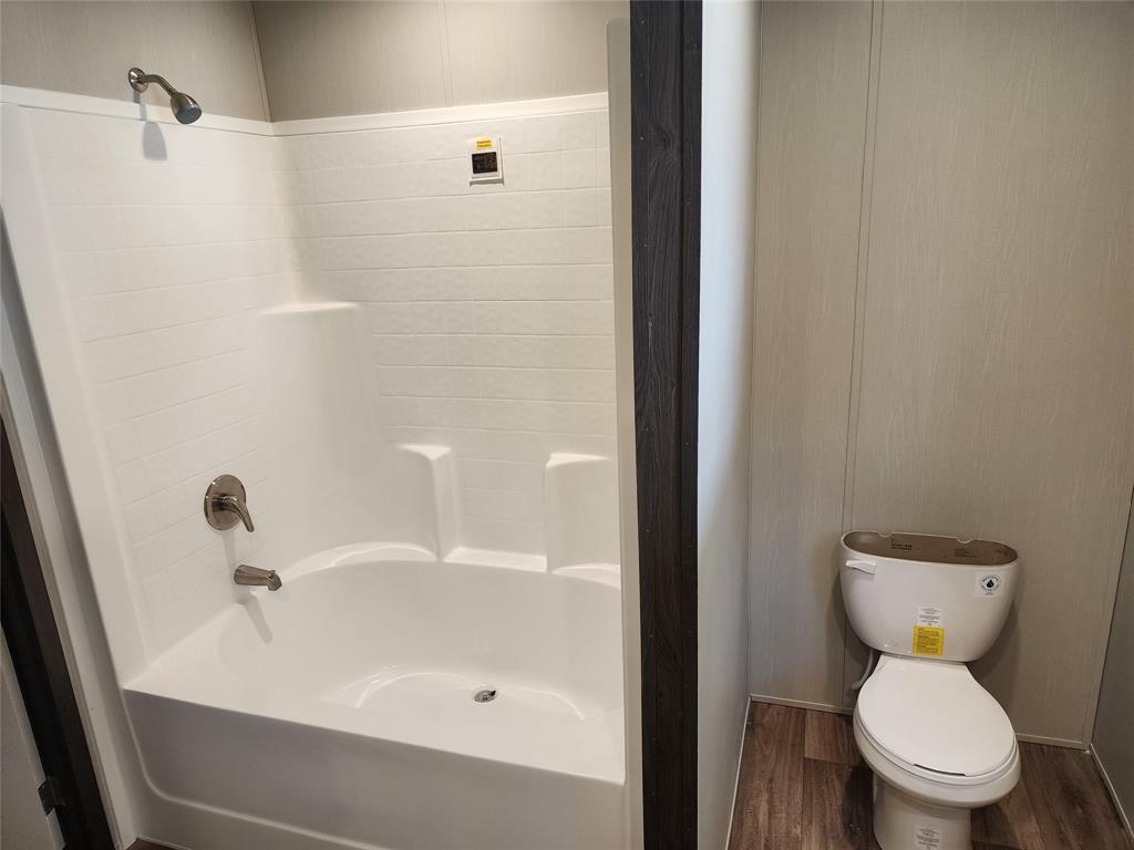 229 Maple Street Mabank, TX 75156 - Photo 15 of 25 a bathroom with a sink and a toilet