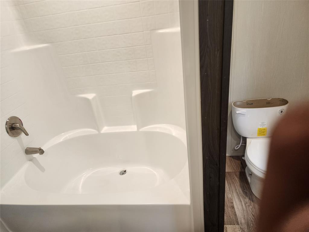 229 Maple Street Mabank, TX 75156 - Photo 16 of 25 a bathroom with a bathtub