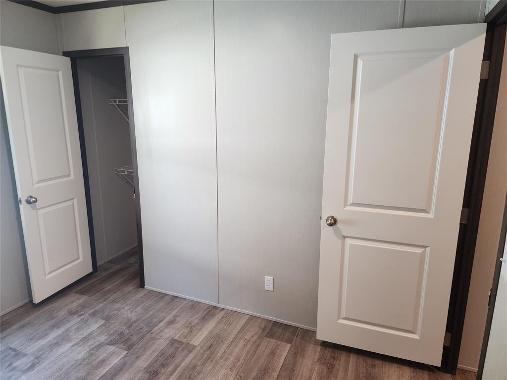 229 Maple Street Mabank, TX 75156 - Photo 20 of 25 a view of an empty room and wooden floor