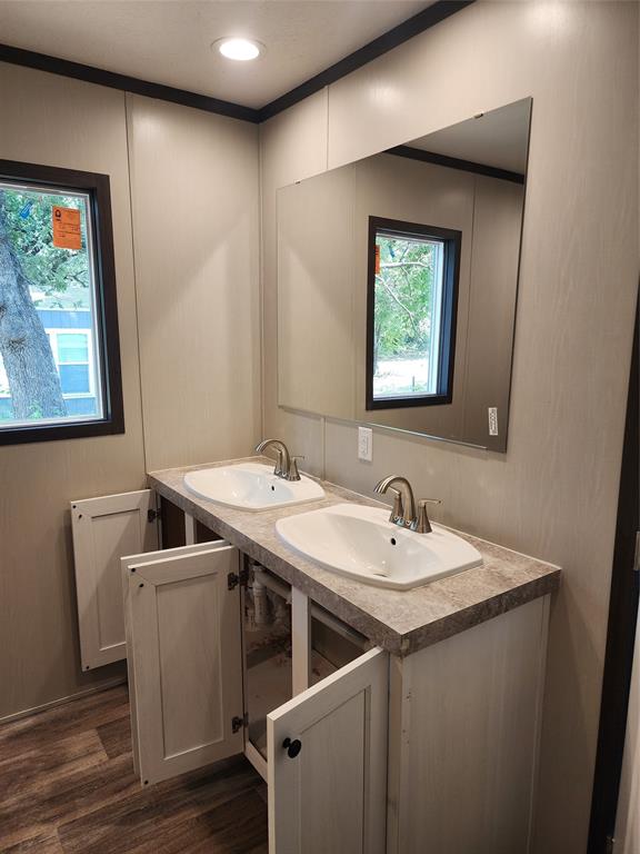 229 Maple Street Mabank, TX 75156 - Photo 22 of 25 a bathroom with a sink and a mirror