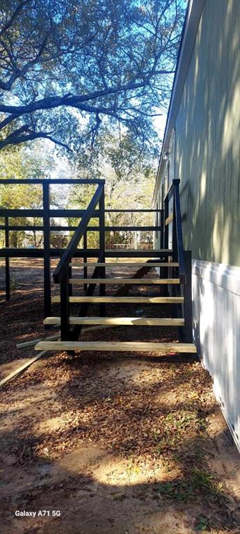 229 Maple Street Mabank, TX 75156 - Photo 4 of 25 a view of room with wooden floor and a fence