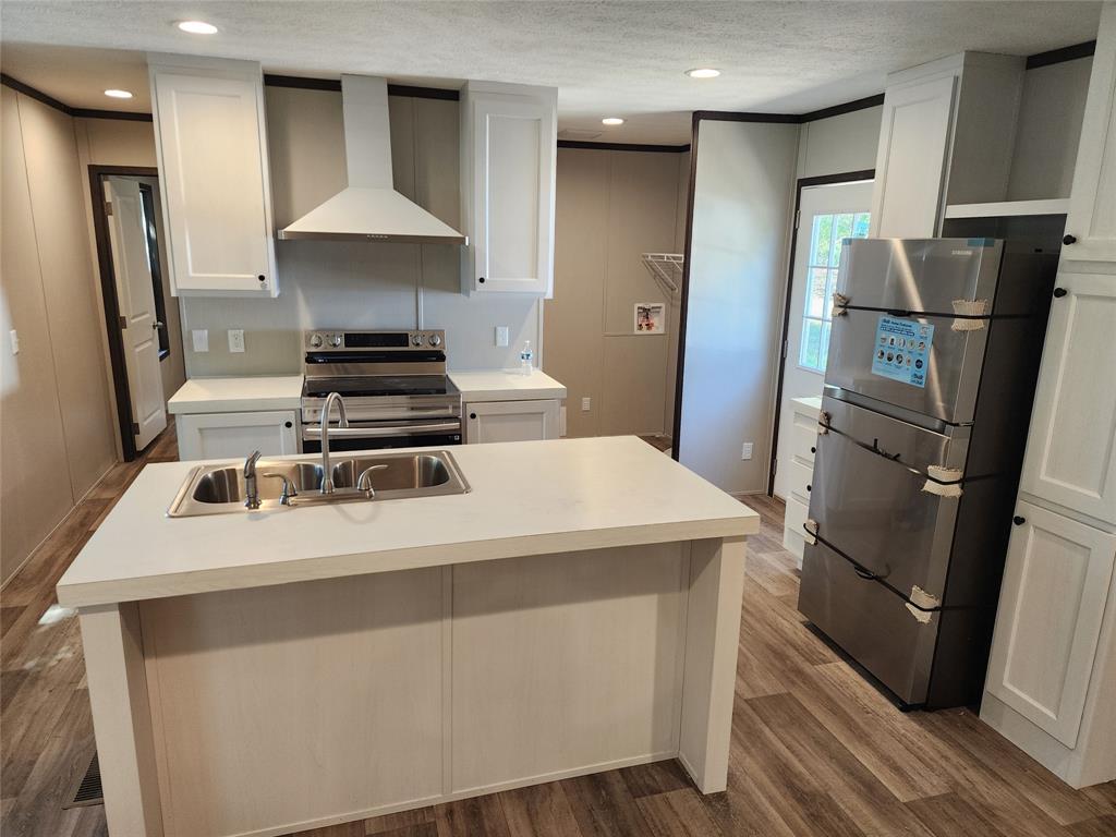 229 Maple Street Mabank, TX 75156 - Photo 9 of 25 a kitchen with a stove and a refrigerator