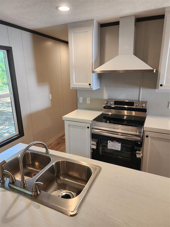 229 Maple Street Mabank, TX 75156 - Photo 10 of 25 a kitchen with a stove and a sink
