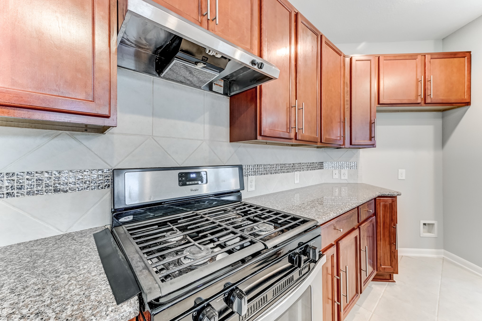 4706 Mint Trail Houston, TX 77066 - Photo 17 of 46 a kitchen with wooden cabinets stove top oven and sink