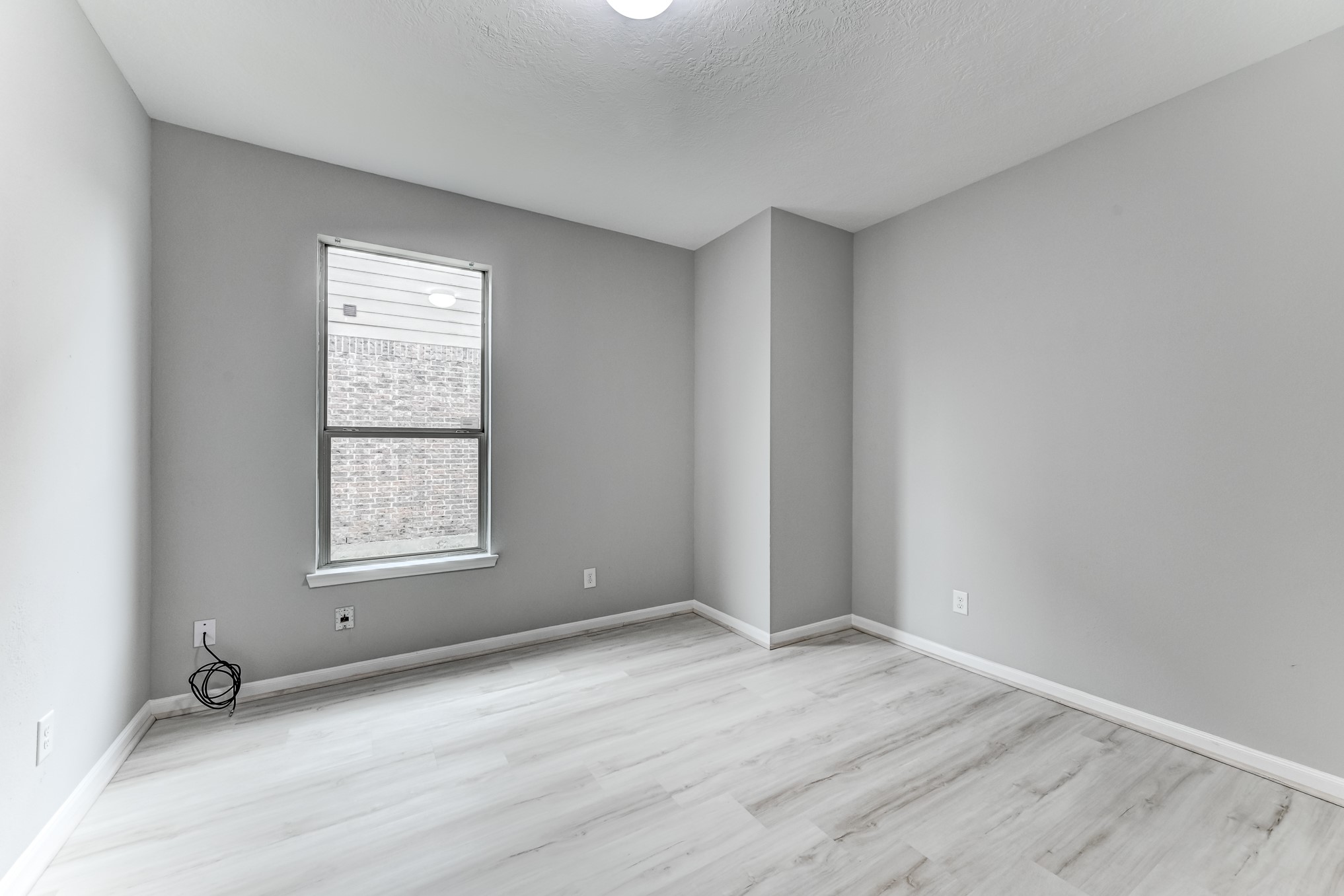4706 Mint Trail Houston, TX 77066 - Photo 19 of 46 an empty room with wooden floor and windows