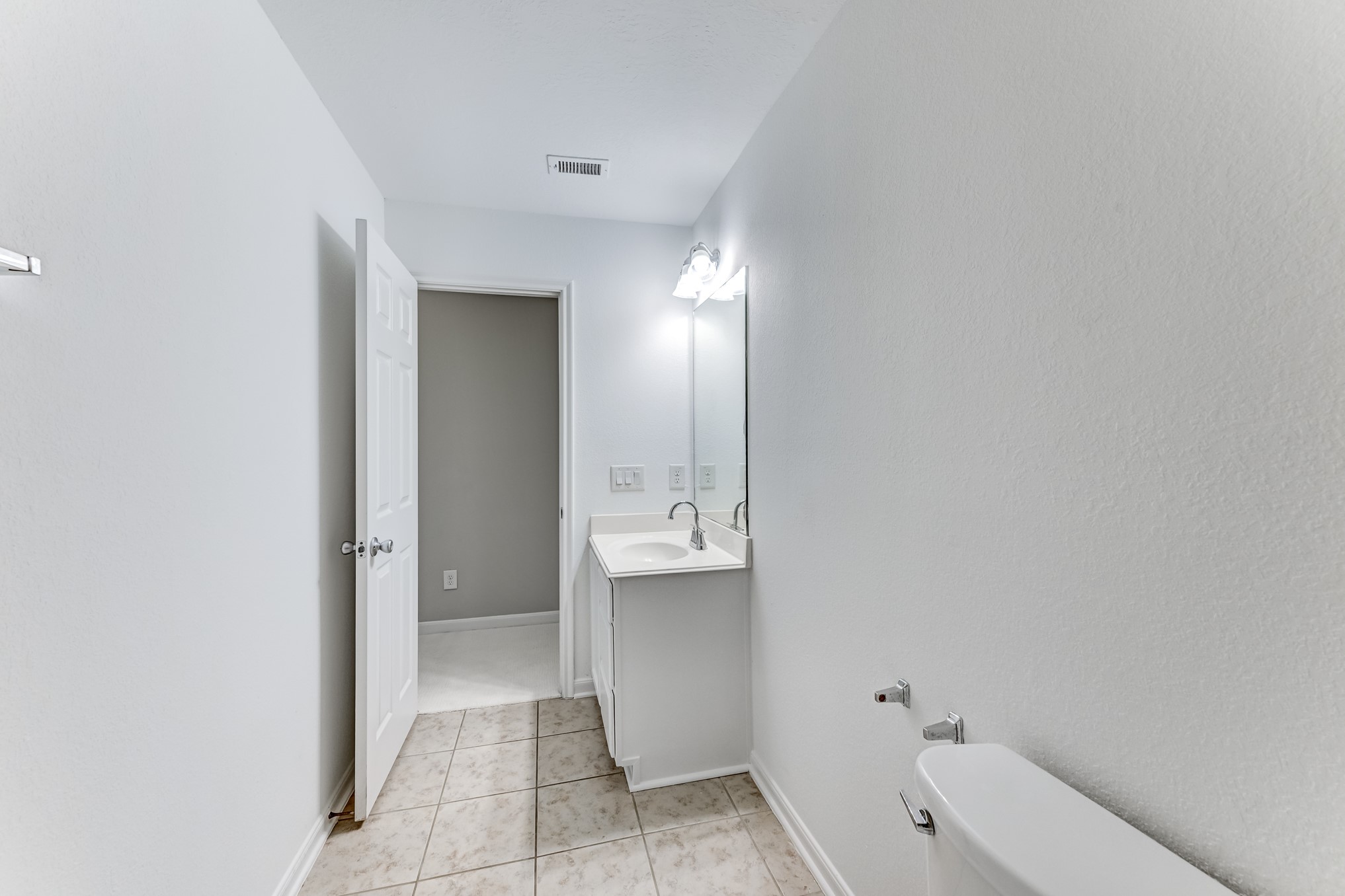 4706 Mint Trail Houston, TX 77066 - Photo 35 of 46 a bathroom with a sink and mirror with toilet
