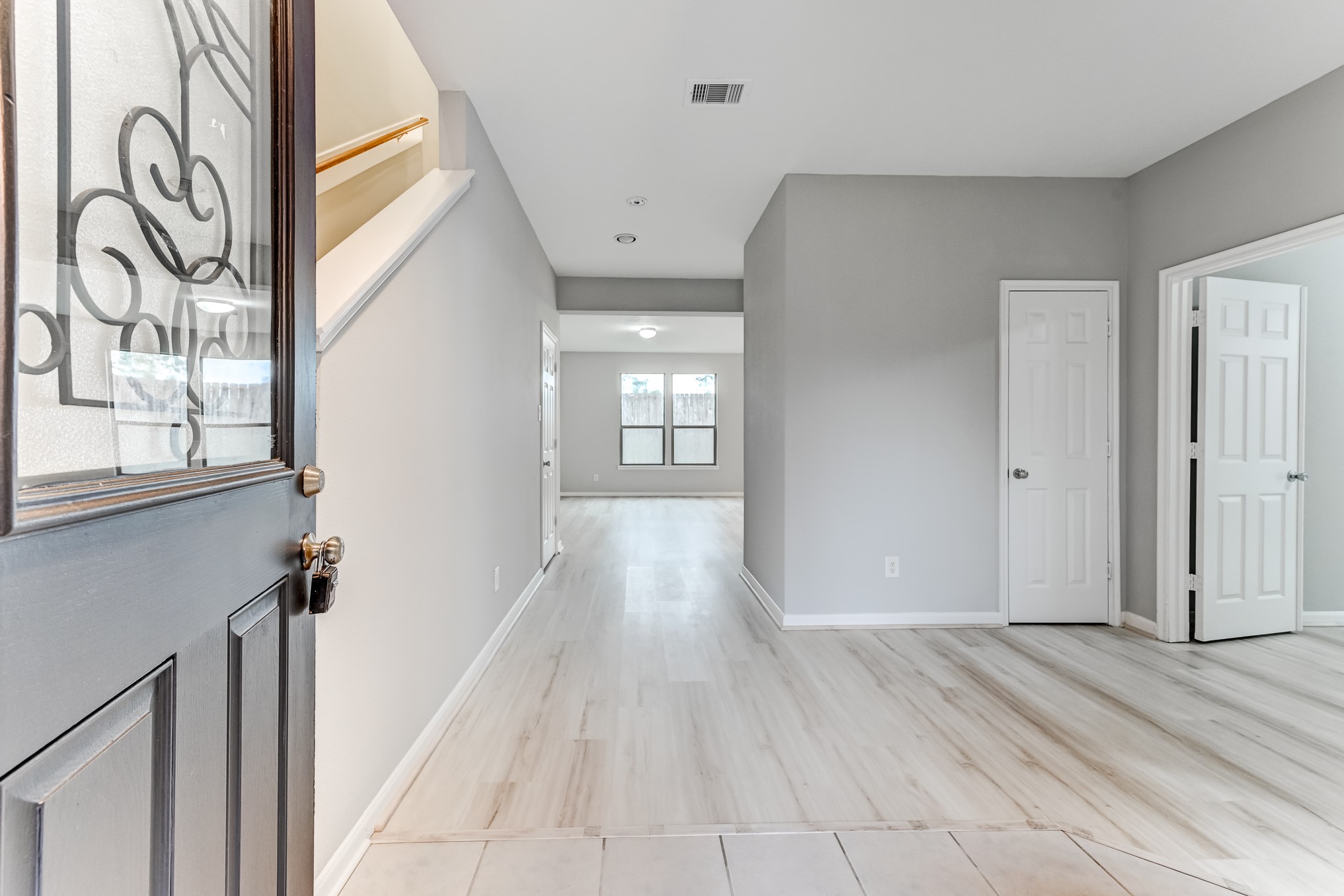 4706 Mint Trail Houston, TX 77066 - Photo 5 of 46 a view of a hallway with wooden floor and glass door