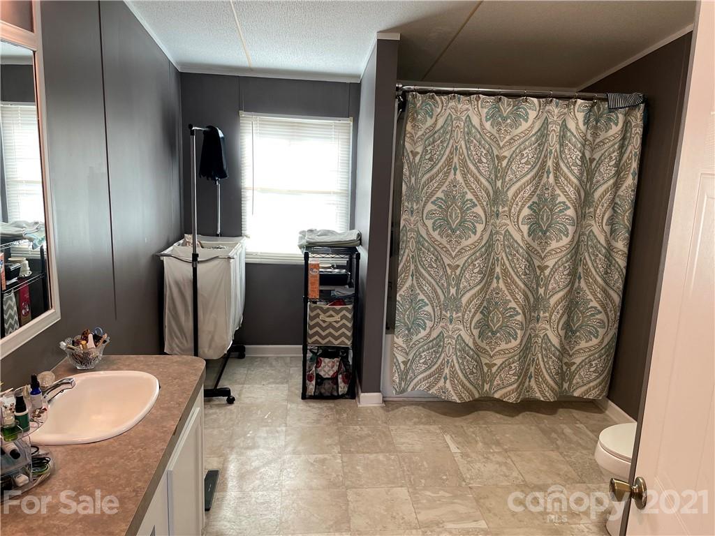 34908 Finger Road Mount Pleasant, NC 28124 - Photo 7 of 14 a bathroom with a granite countertop sink and a mirror