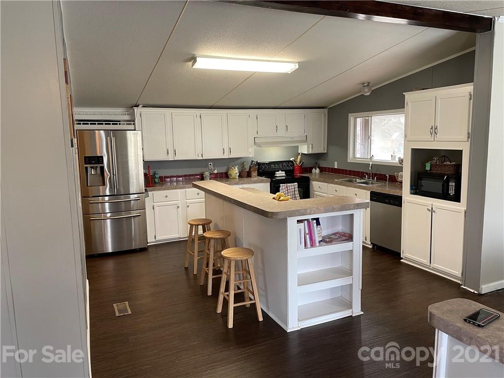 34908 Finger Road Mount Pleasant, NC 28124 - Photo 8 of 14 a kitchen with a sink a counter top space stainless steel appliances and cabinets