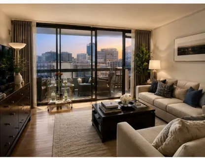 a living room with furniture tv and a large window