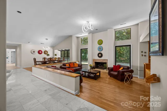a living room with furniture and large windows