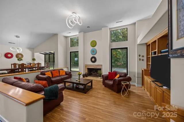a living room with fireplace furniture and a flat screen tv
