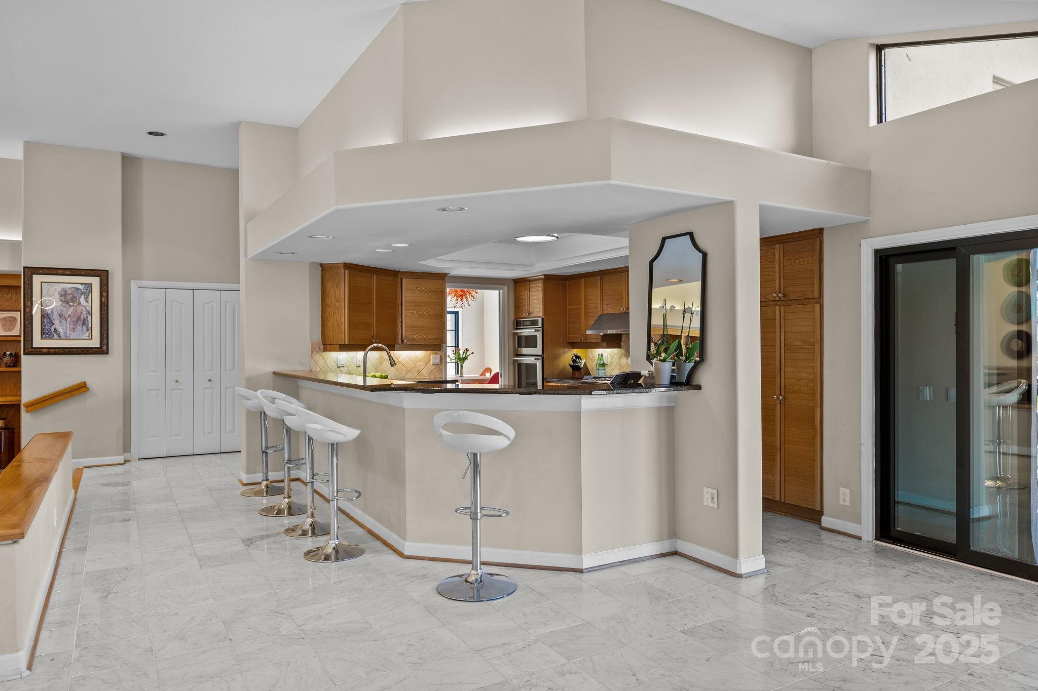 21400 Bethel Church Road Cornelius, NC 28031 - Photo 16 of 47 a living room with stainless steel appliances kitchen island granite countertop furniture and a refrigerator