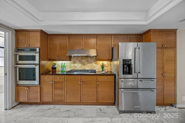 a kitchen with a refrigerator and a stove
