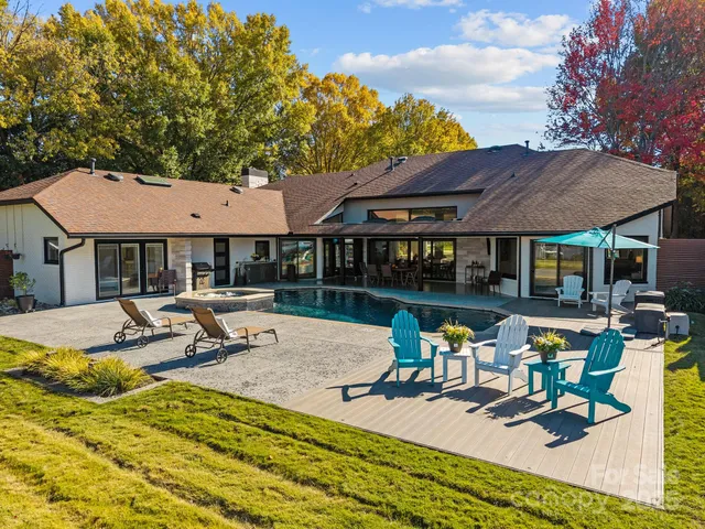 a view of pool with outdoor seating water slide and yard