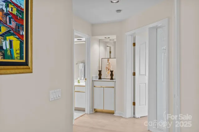 a view of a bedroom with wooden floor and cabinet