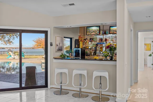 a view of a dining room with furniture a chandelier and window