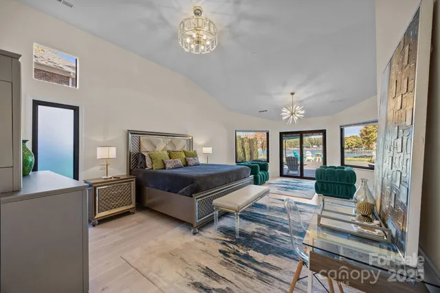 a living room with a bed furniture and a large window