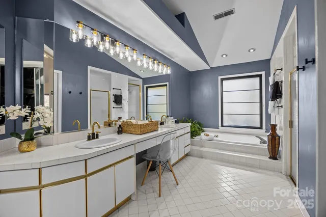 a bathroom with a double vanity sink and a mirror