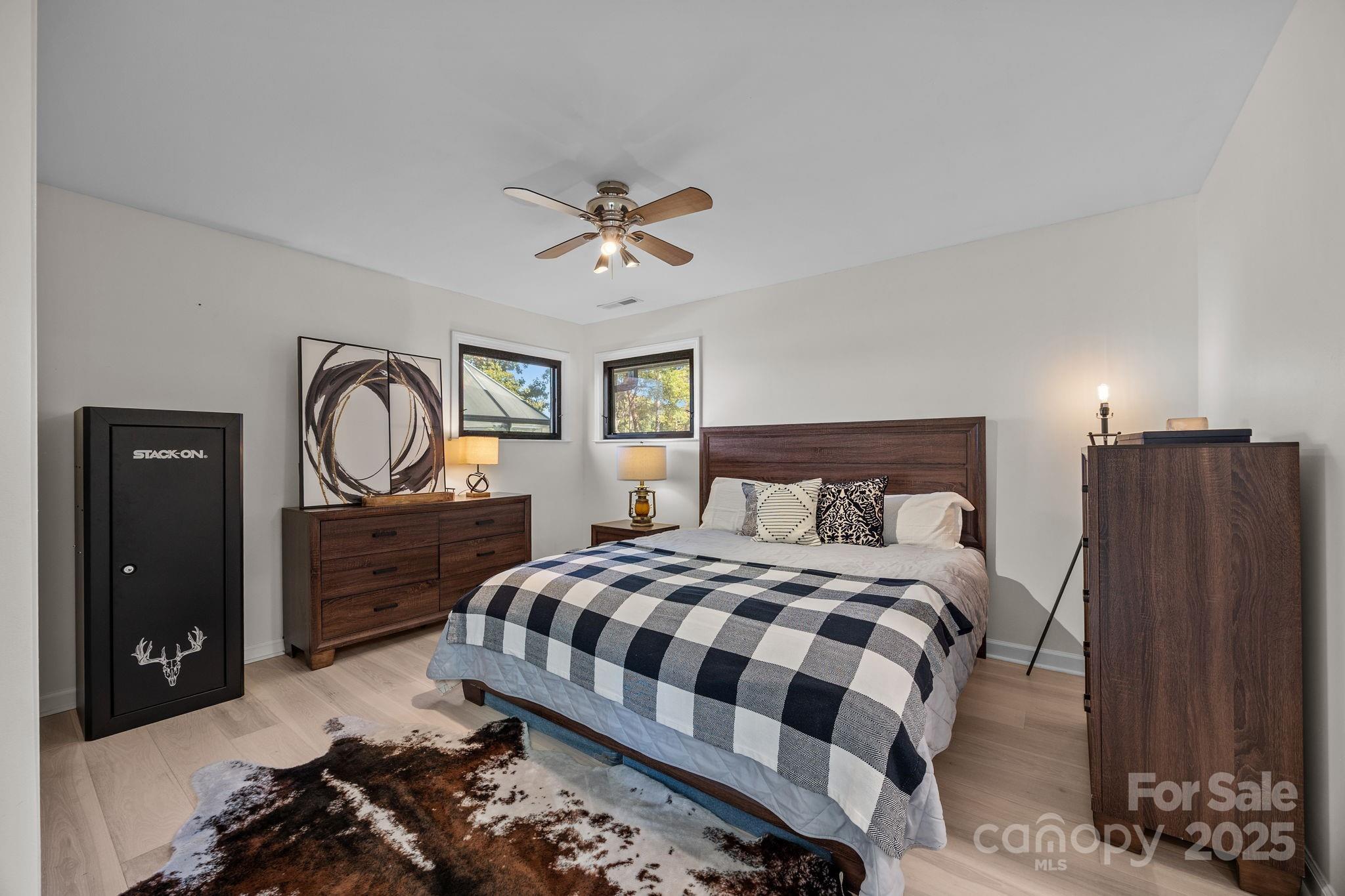 21400 Bethel Church Road Cornelius, NC 28031 - Photo 31 of 47 a bedroom with a bed and a chandelier