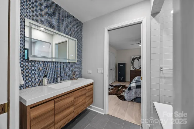 a en suite bathroom with a sink and mirror