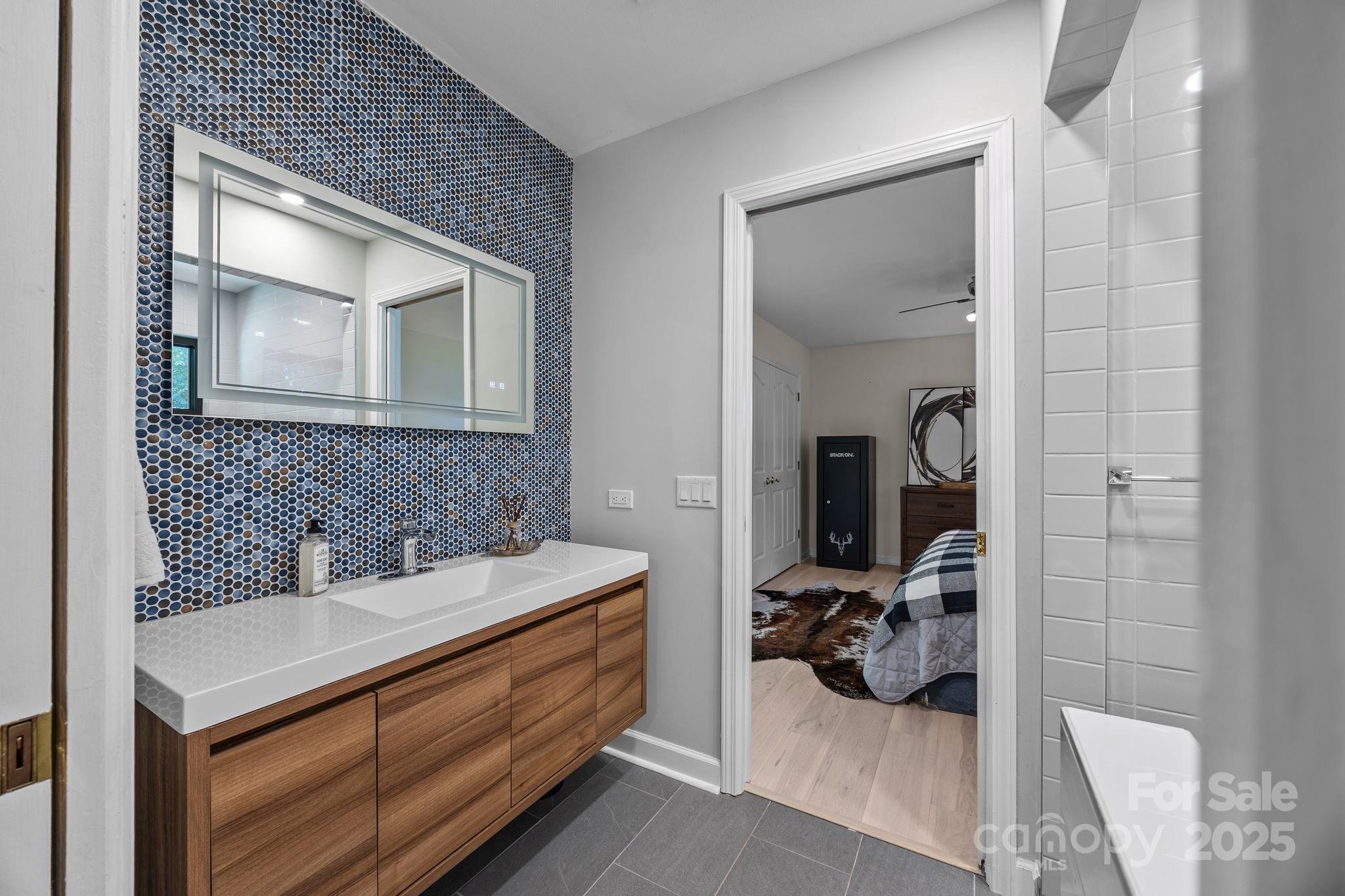 21400 Bethel Church Road Cornelius, NC 28031 - Photo 33 of 47 a en suite bathroom with a sink and mirror