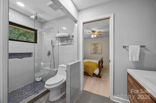 a bathroom with a toilet sink and shower