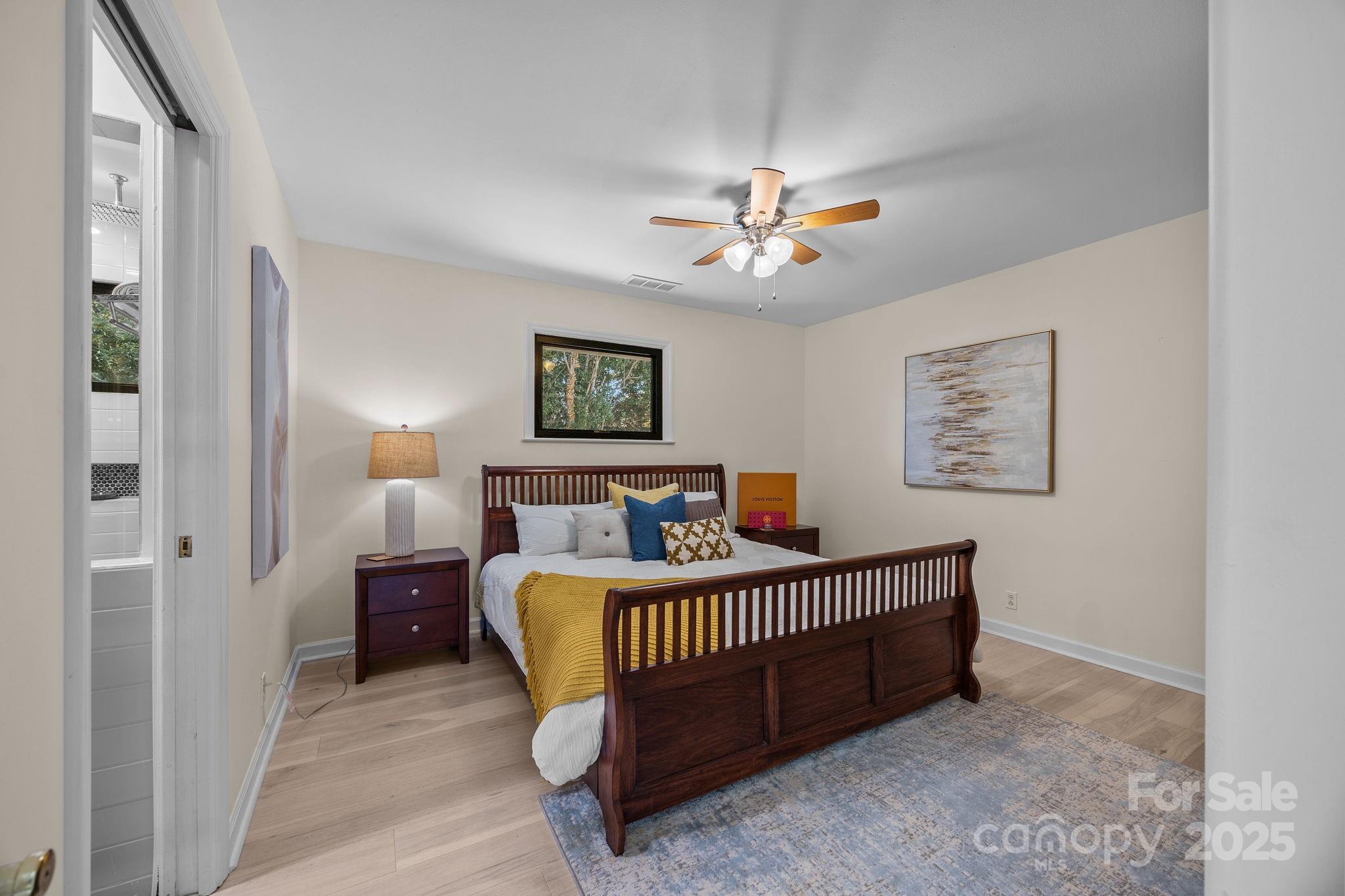 21400 Bethel Church Road Cornelius, NC 28031 - Photo 35 of 47 a bedroom with a bed and a chandelier