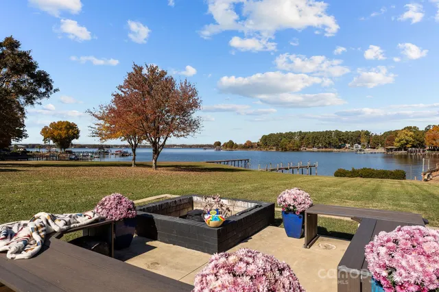 a view of a lake with couches chair and city view