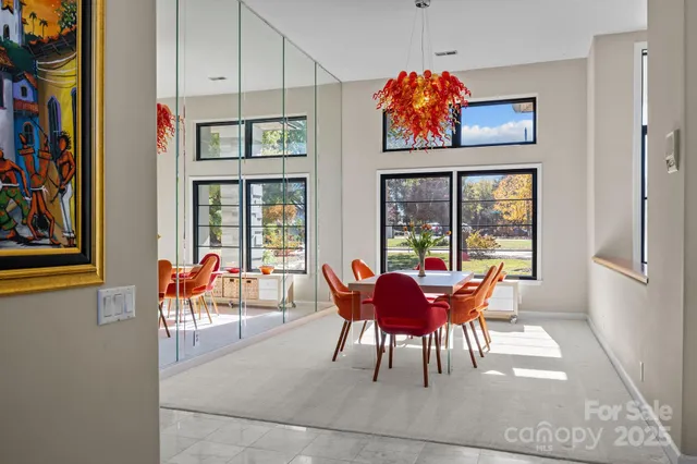 a dining room with furniture a chandelier and wooden floor