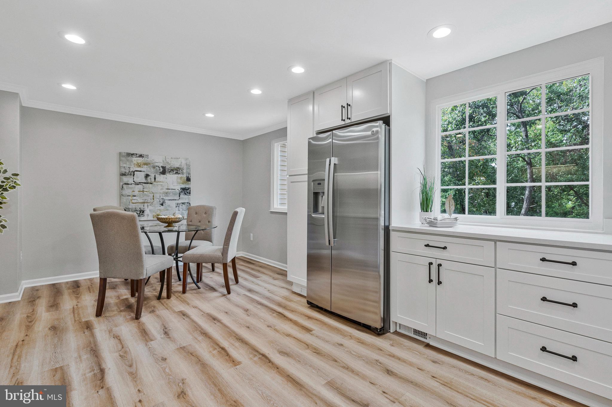 1628 Barnstead Drive Reston, VA 20194 - Photo 14 of 41 a kitchen with stainless steel appliances granite countertop a stove a refrigerator a table and chairs