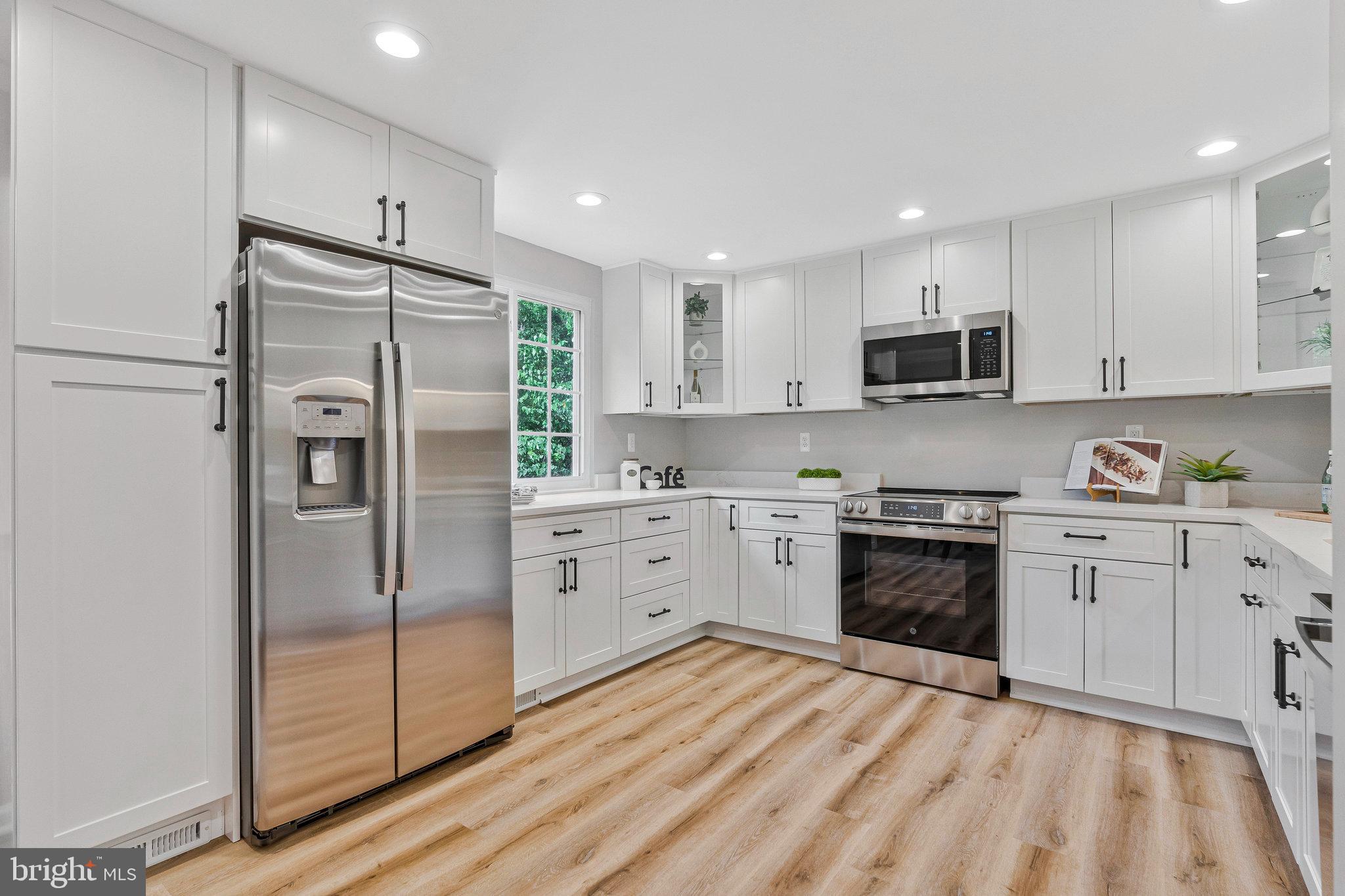 1628 Barnstead Drive Reston, VA 20194 - Photo 15 of 41 a kitchen with stainless steel appliances a refrigerator sink and microwave
