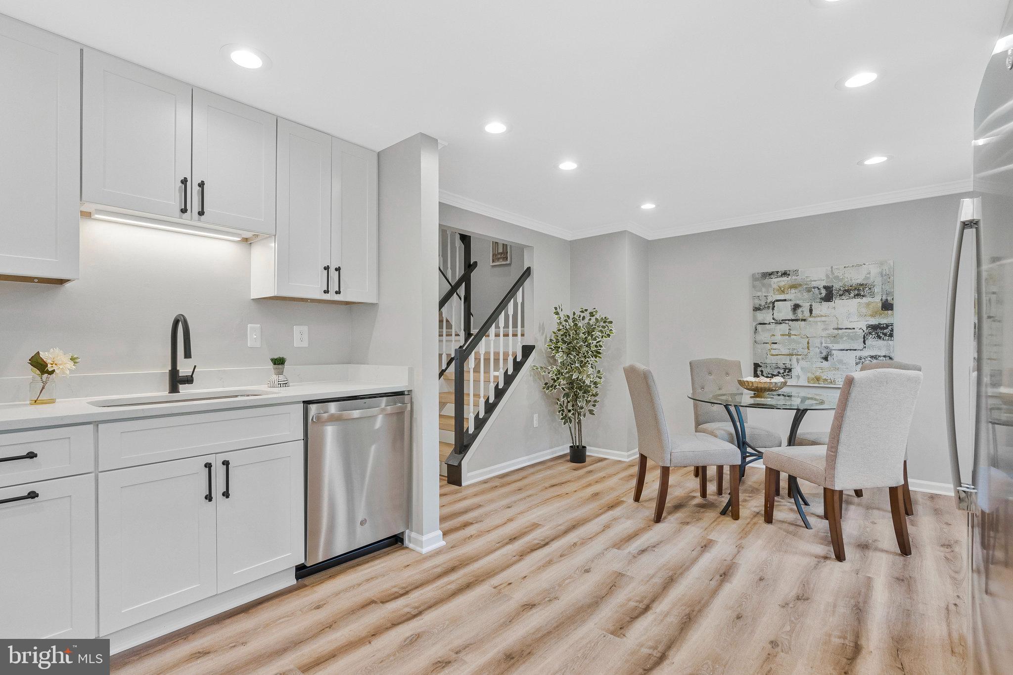 1628 Barnstead Drive Reston, VA 20194 - Photo 16 of 41 a kitchen with white cabinets stainless steel appliances and wooden floor