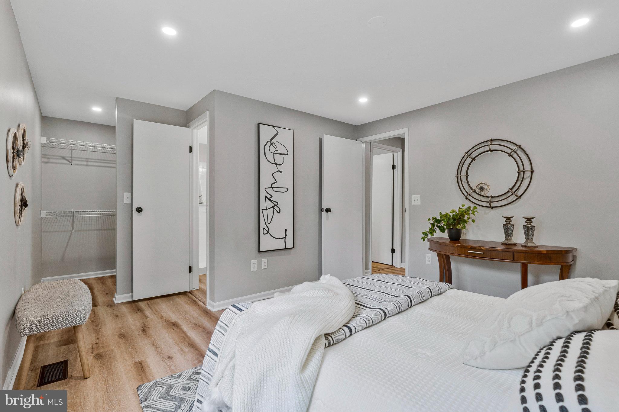 1628 Barnstead Drive Reston, VA 20194 - Photo 19 of 41 a bedroom with a bed and a chandelier