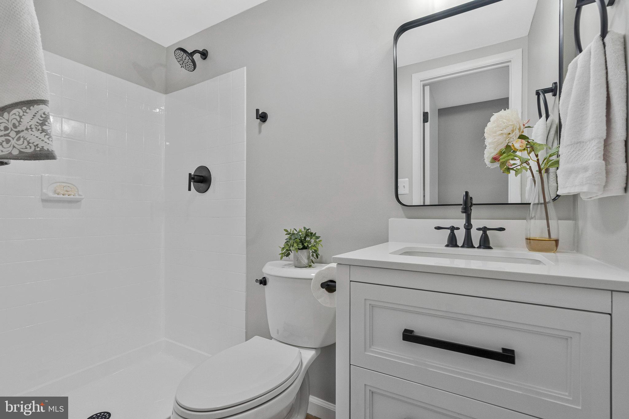 1628 Barnstead Drive Reston, VA 20194 - Photo 20 of 41 a bathroom with a sink vanity mirror and toilet