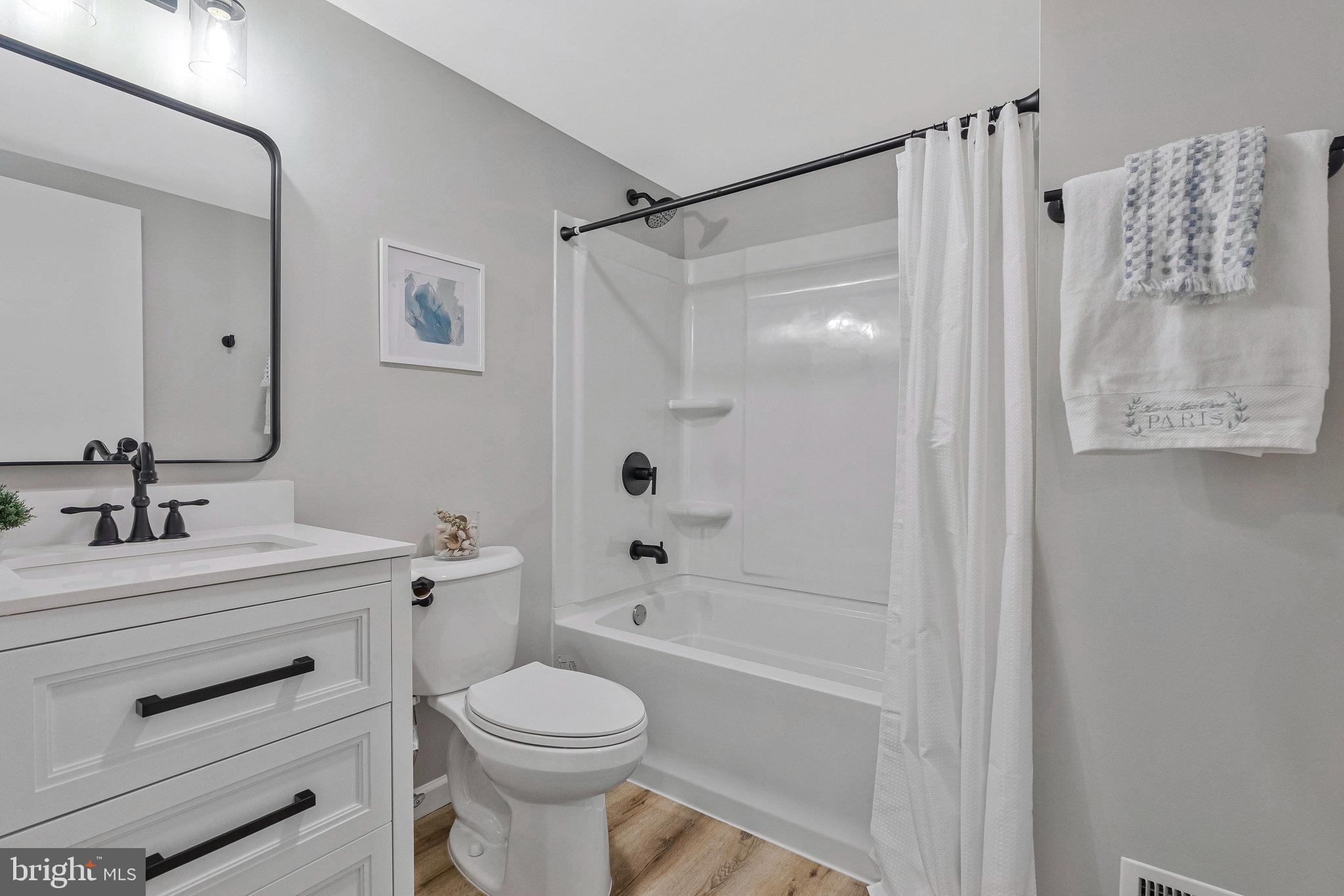 1628 Barnstead Drive Reston, VA 20194 - Photo 25 of 41 a bathroom with a sink toilet a mirror and shower