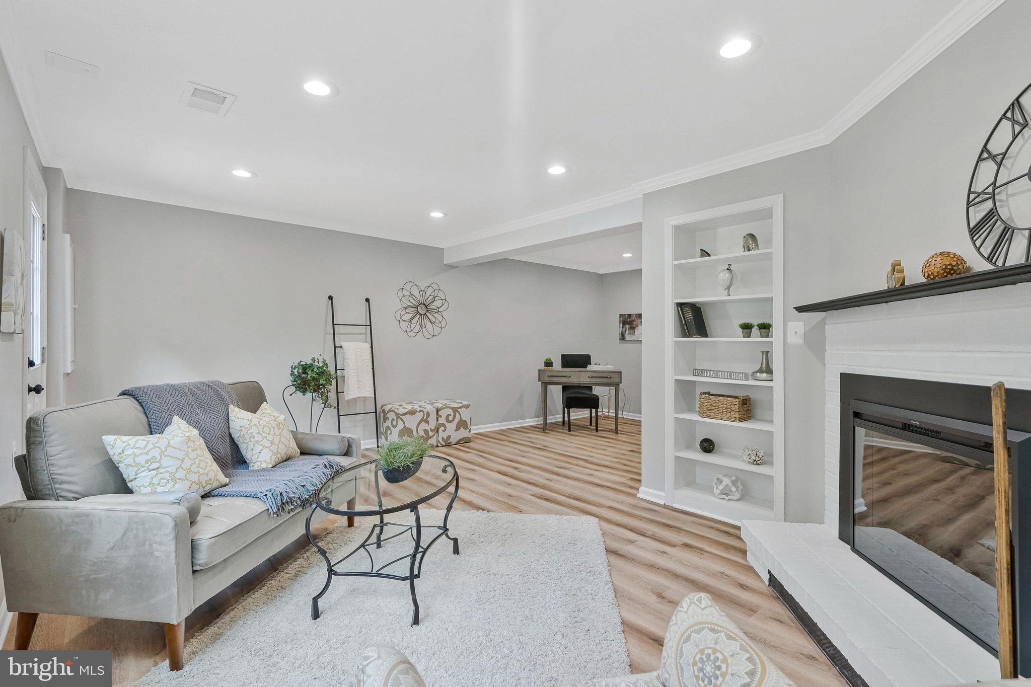 1628 Barnstead Drive Reston, VA 20194 - Photo 27 of 41 a living room with furniture and a fireplace
