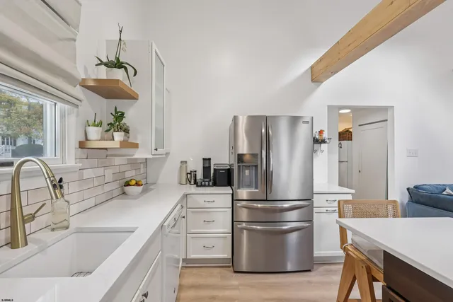 a kitchen with a refrigerator sink and stove