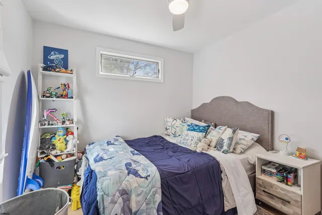 a bedroom with a bed and a window