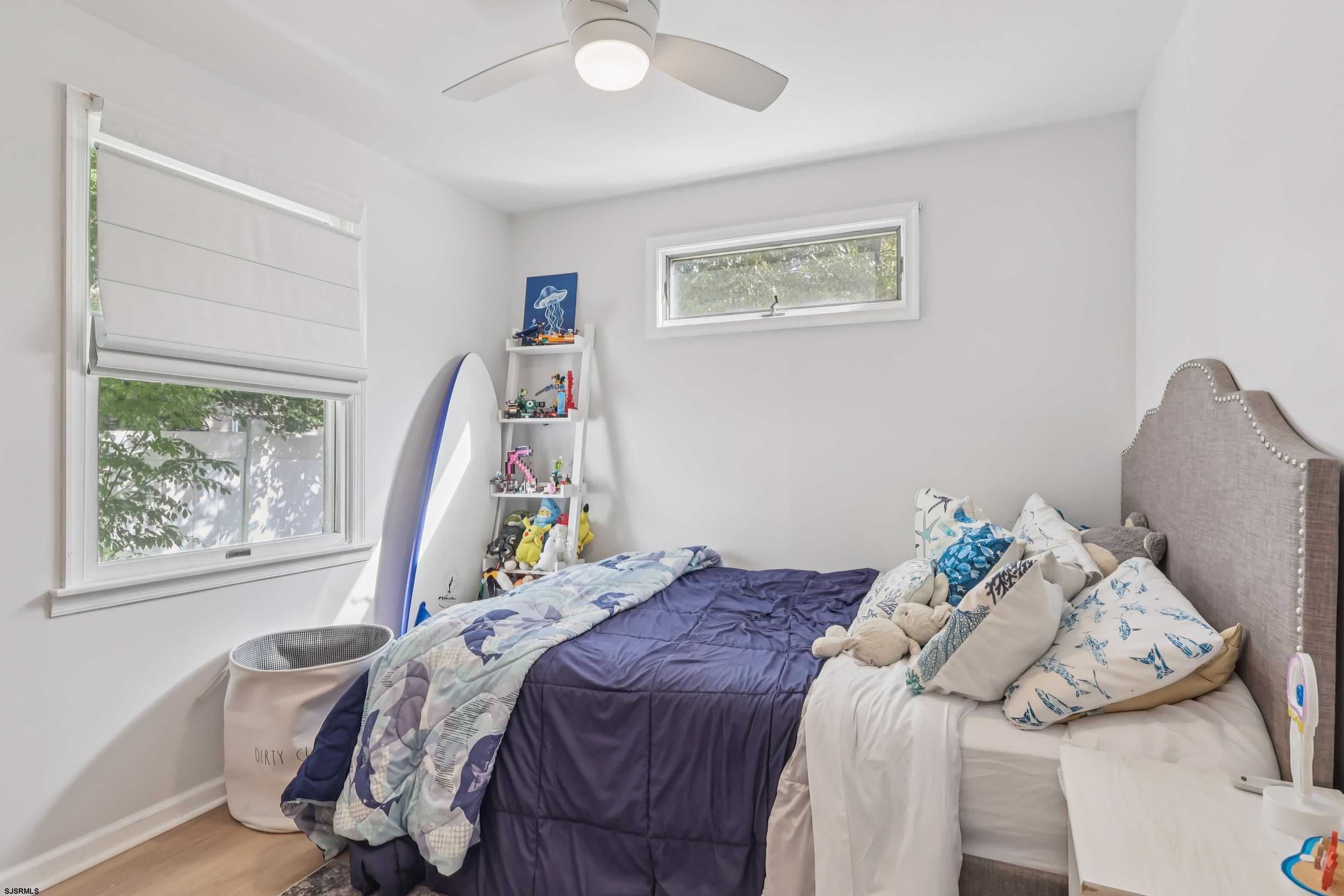 746 4th Street Somers Point, NJ 08244 - Photo 20 of 39 a bed sitting in a bedroom next to a window