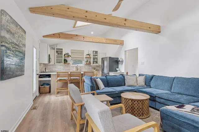 a living room with furniture and a dining table