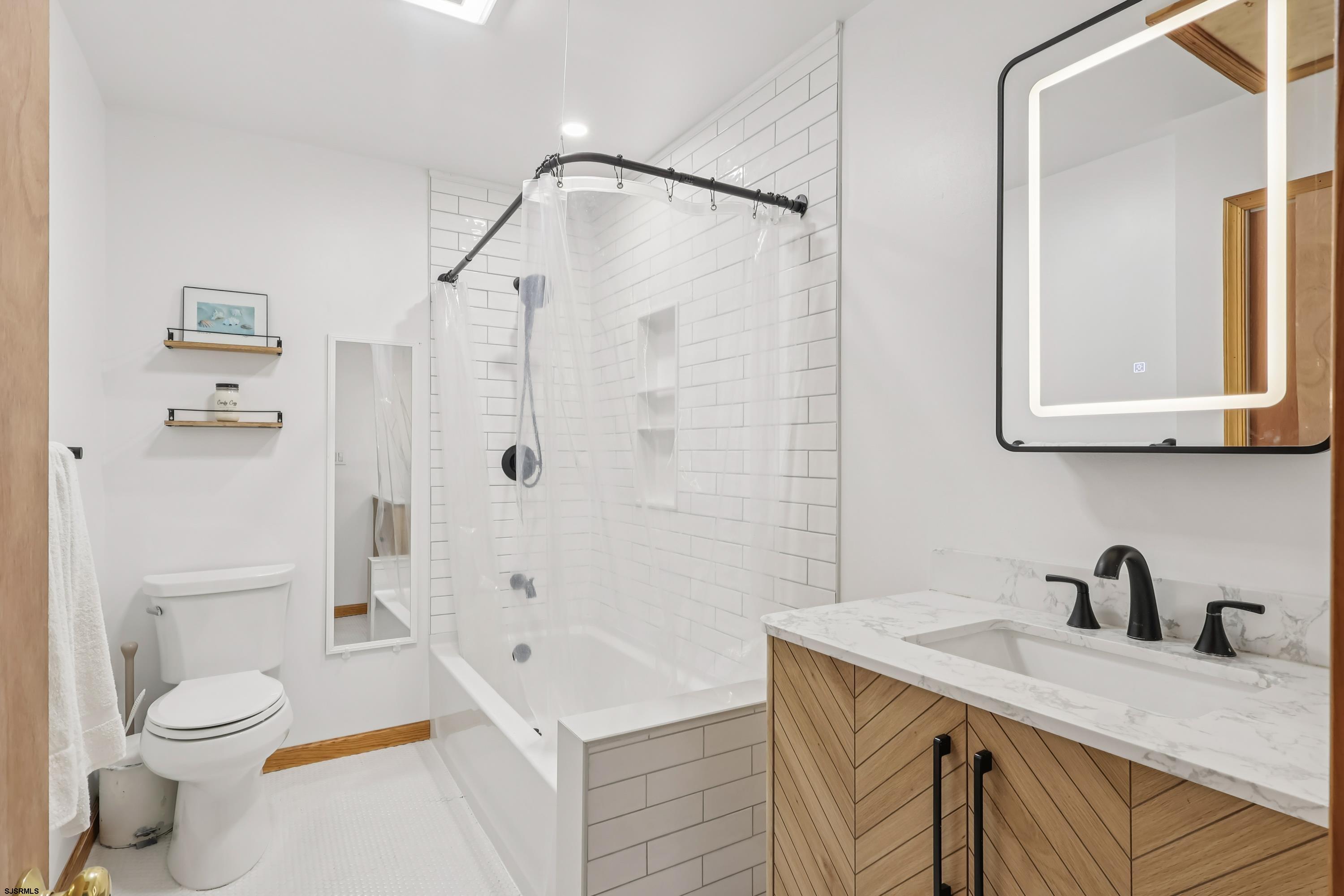 746 4th Street Somers Point, NJ 08244 - Photo 21 of 39 a bathroom with a granite countertop sink a toilet and shower