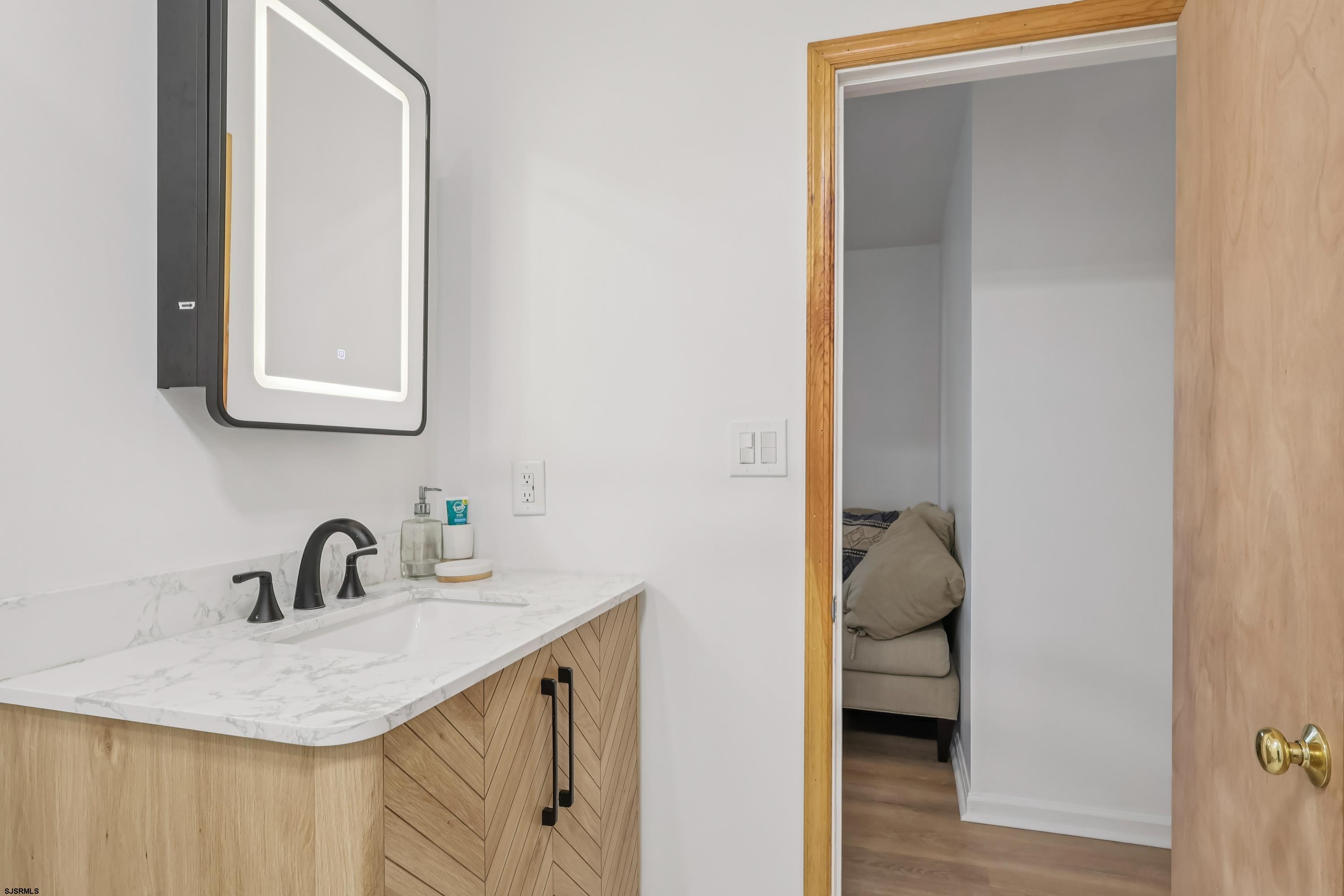 746 4th Street Somers Point, NJ 08244 - Photo 22 of 39 a bathroom with a sink and a mirror