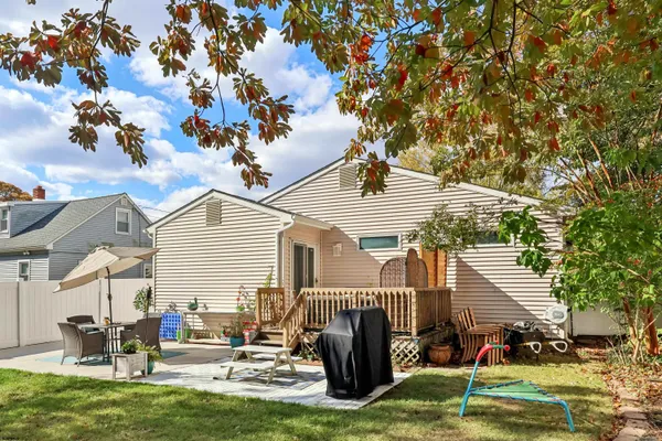 a backyard of a house with table and chairs